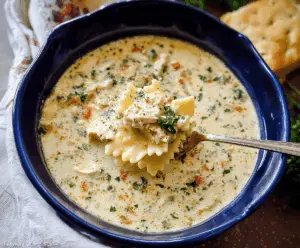 Creamy One-Pot White Chicken Lasagna Soup with shredded chicken, spinach, and melted cheese in a flavorful broth