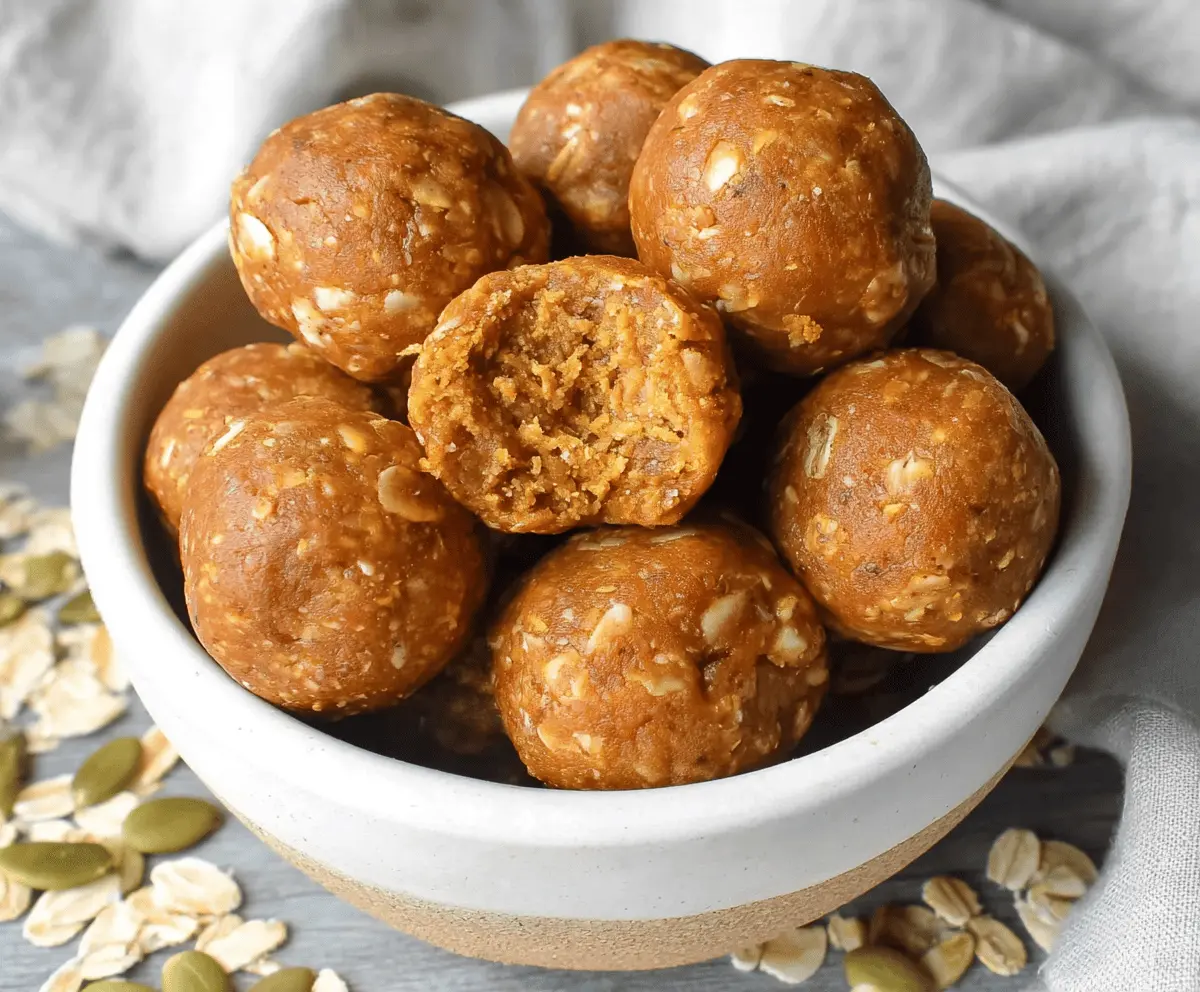 Healthy Almond Butter Pumpkin Protein Balls on a white plate with cinnamon and pumpkin seeds, perfect for a nutritious snack