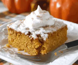 Delicious homemade Pumpkin 3 Ingredient Cake topped with whipped cream and cinnamon, perfect for fall desserts